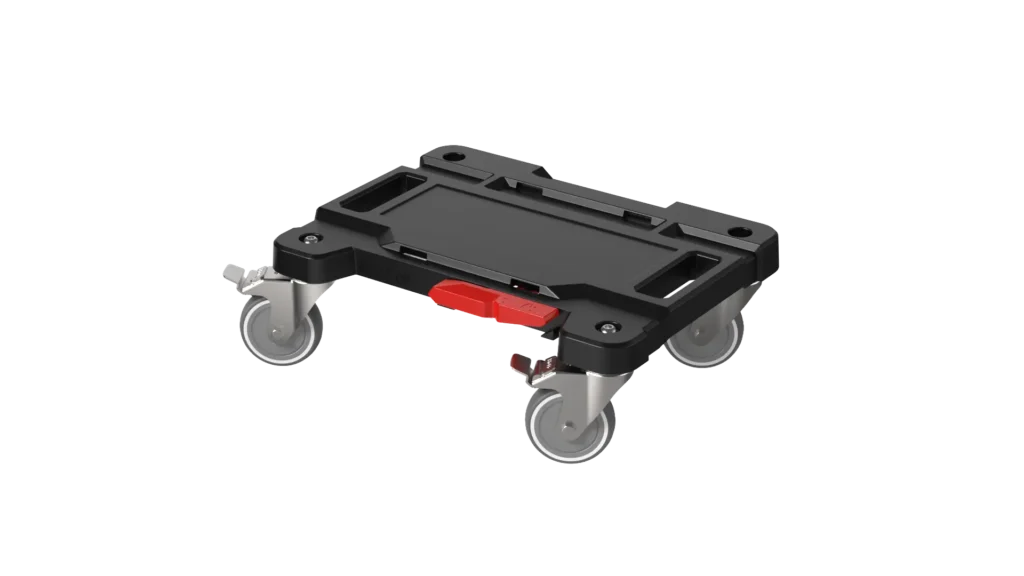 Low-profile black mobile dolly with four caster wheels and a red locking lever on a white background