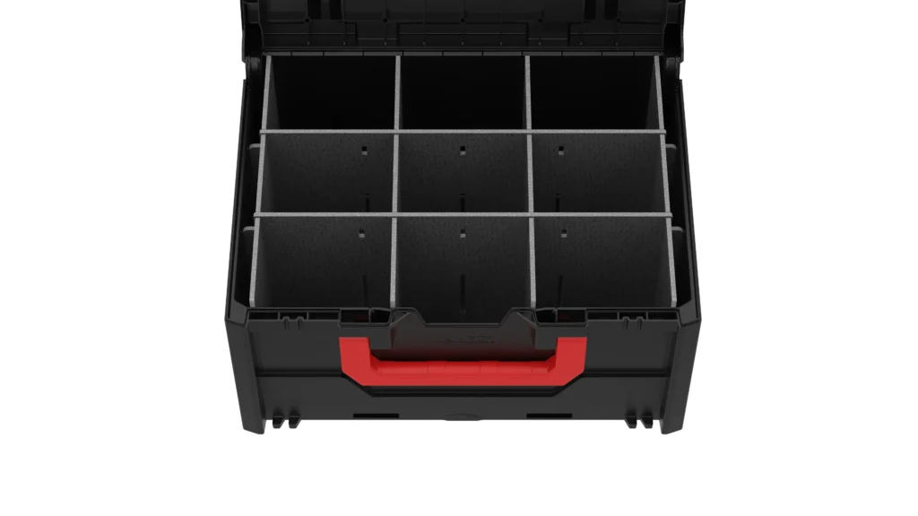 Top-down view of a black toolbox drawer with nine evenly divided compartments and a red handle at the front (empty storage bins)